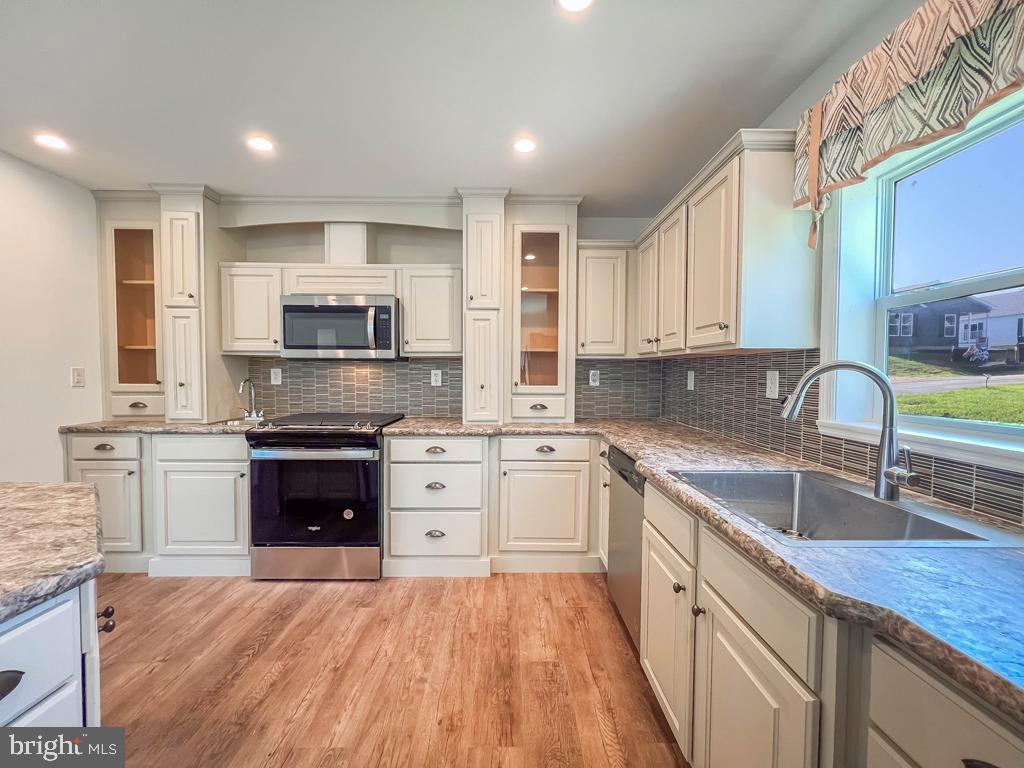146 Minch Road Parkesburg, PA 19365 - Photo 11 of 44 a kitchen with kitchen island granite countertop a stove sink and microwave