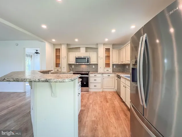 a kitchen with a refrigerator a sink and cabinets