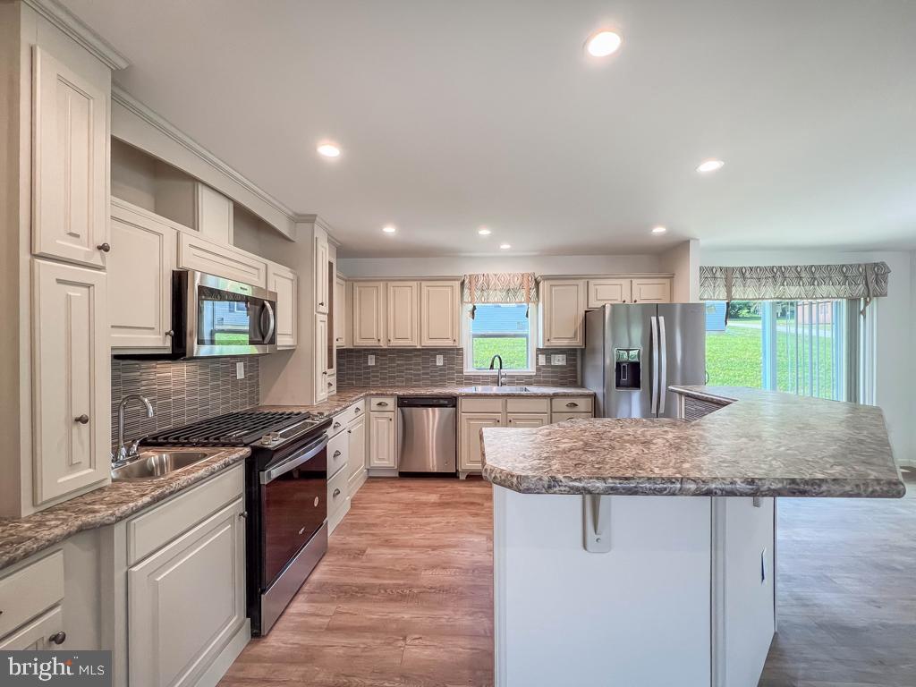 146 Minch Road Parkesburg, PA 19365 - Photo 15 of 44 a kitchen with stainless steel appliances granite countertop a stove top oven a sink and dishwasher