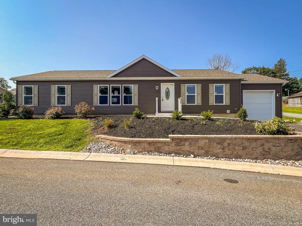 146 Minch Road Parkesburg, PA 19365 - Photo 2 of 44 a front view of a house with a yard and garage