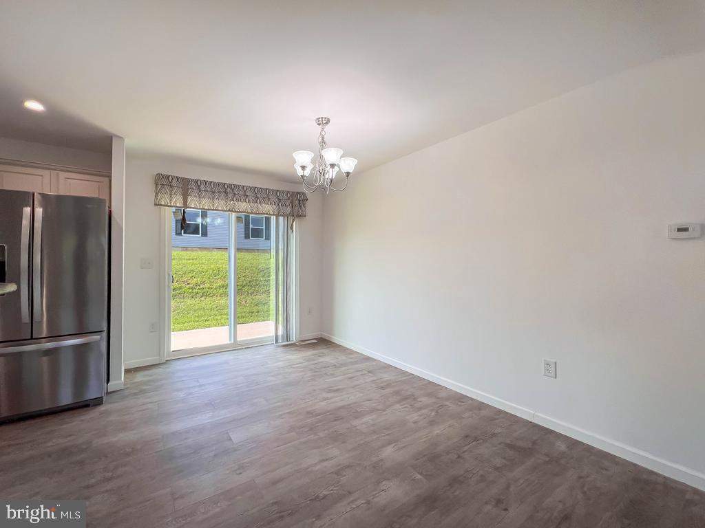 146 Minch Road Parkesburg, PA 19365 - Photo 23 of 44 a view of an empty room with a window and kitchen view