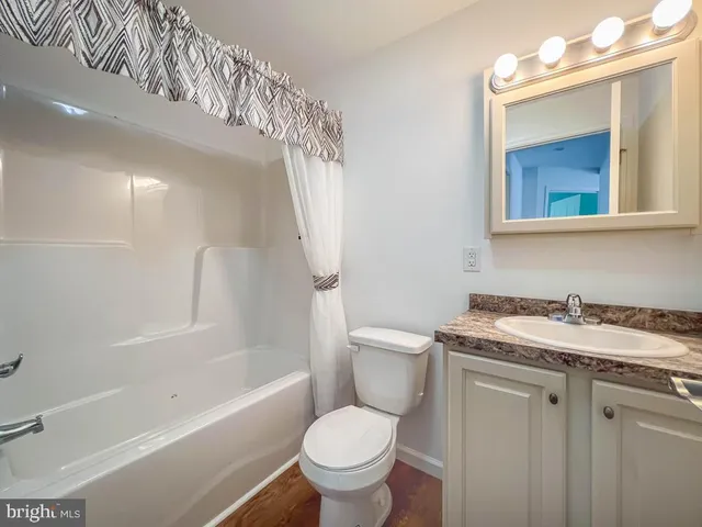 a white toilet sitting next to a bath tub