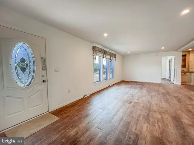 a view of a kitchen with a sink and a refrigerator