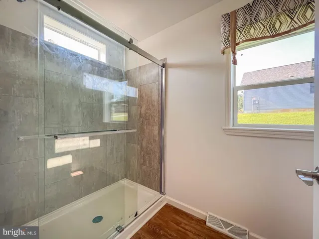 a bathroom with a glass shower door