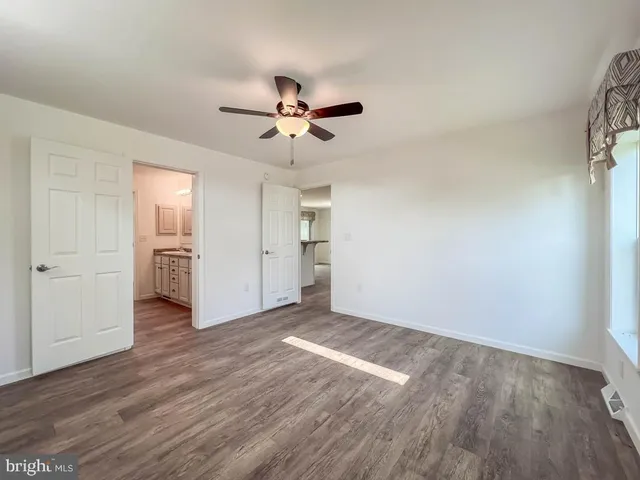 a view of an room with wooden floor and a ceiling fan