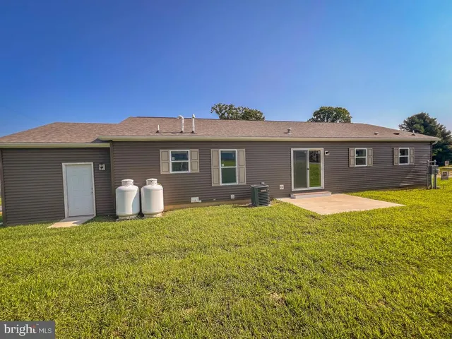 a front view of a house with yard and green space