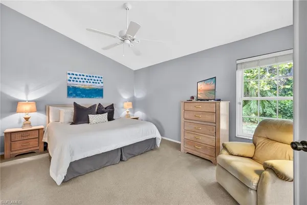 a spacious bedroom with a bed and furniture