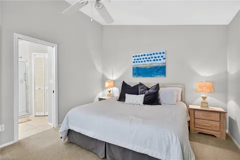 a bedroom with a bed and a painting on the wall