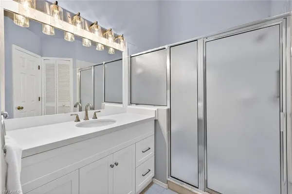 a bathroom with a double vanity sink and mirror