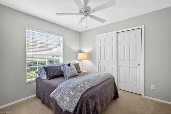 a bedroom with bed and window
