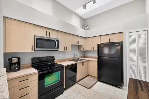 a kitchen with a refrigerator stove and microwave