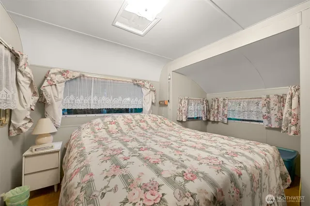 a bedroom with a large bed and a dresser