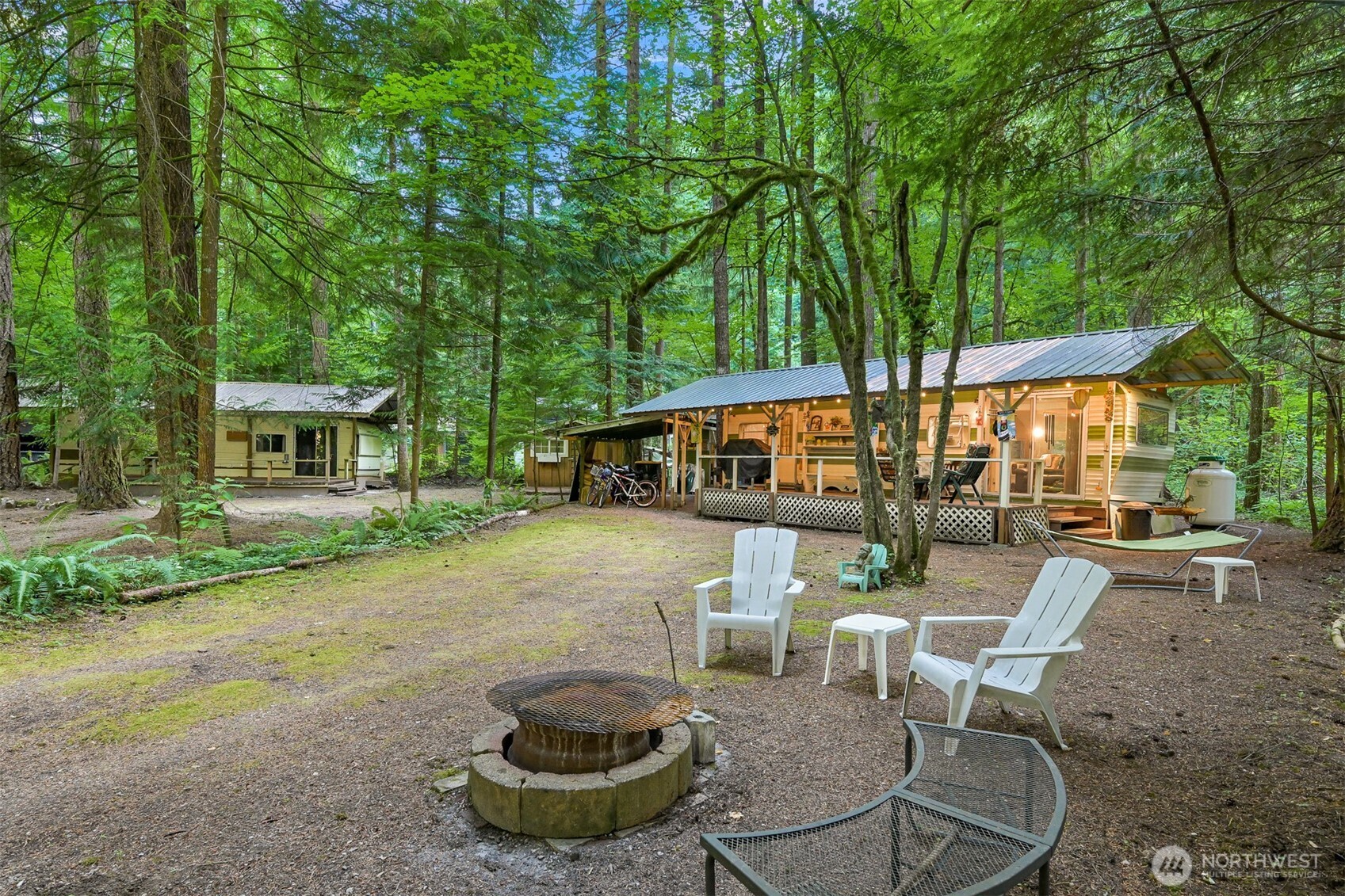 1107 Birch Lane Maple Falls, WA 98266 - Photo 14 of 40 a view of a patio with table and chairs potted plants and large tree