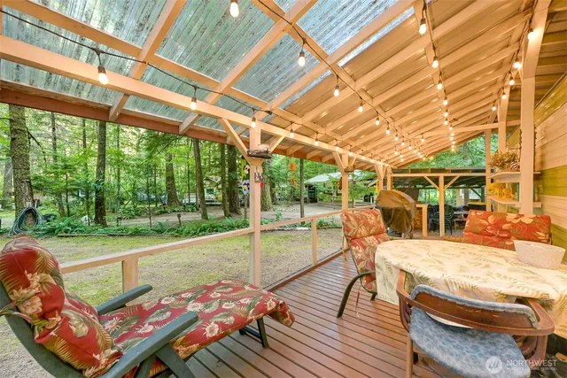 a view of outdoor space table and chairs under an umbrella