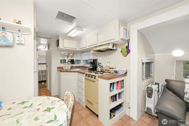 a kitchen with kitchen island a sink stove and refrigerator