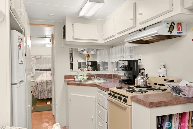a kitchen with stainless steel appliances granite countertop a stove and a refrigerator