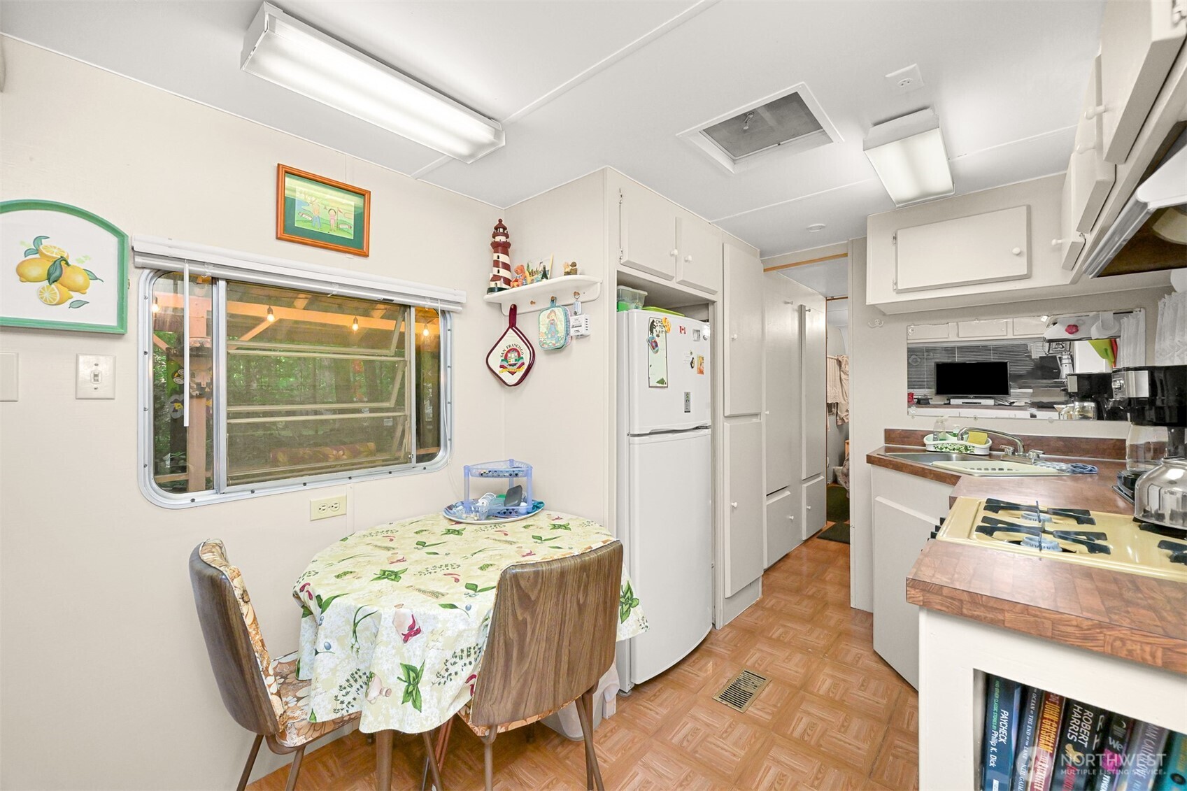 1107 Birch Lane Maple Falls, WA 98266 - Photo 9 of 40 a kitchen with stainless steel appliances kitchen island granite countertop a refrigerator a stove top oven and a dining table with wooden floor