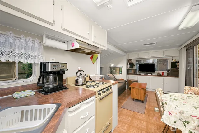 a kitchen with stainless steel appliances kitchen island granite countertop a sink and cabinets