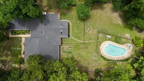an aerial view of a house with garden space sitting space and swimming pool