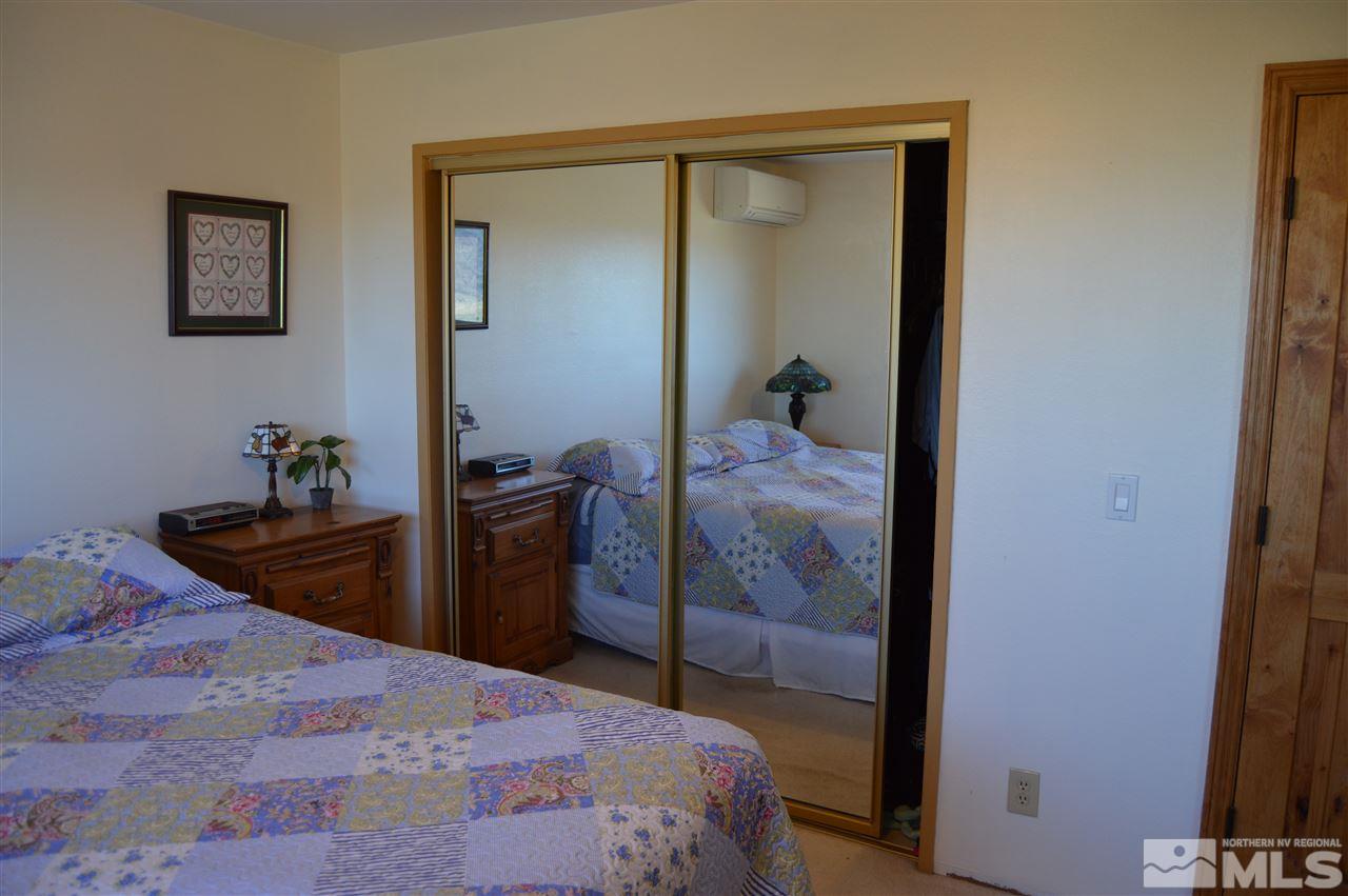 5860 Quaking Aspen Road Reno, NV 89510 - Photo 17 of 25 a bedroom with a bed and a mirror