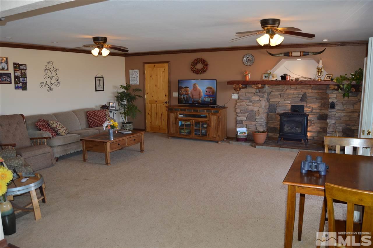 5860 Quaking Aspen Road Reno, NV 89510 - Photo 10 of 25 a living room with furniture a flat screen tv and a fireplace