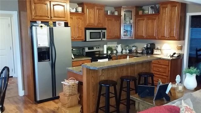 5846 Shady Grove Road Morrison, TN 37357 - Photo 5 of 20 a kitchen with stainless steel appliances granite countertop a refrigerator and a stove top oven