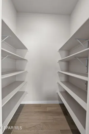 a view of walk in closet with empty racks