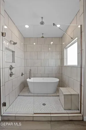 a bathroom with a bathtub and shower