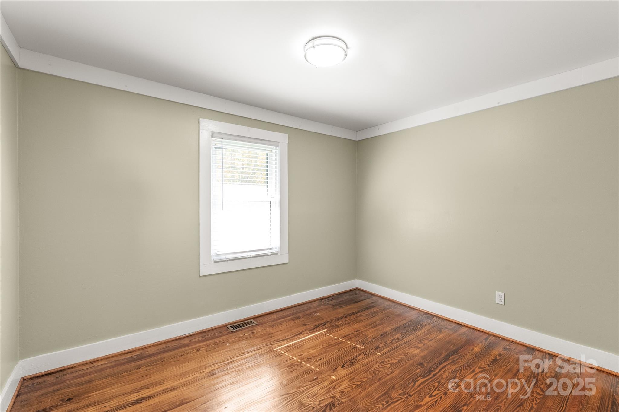 1914 John Moore Road Monroe, NC 28110 - Photo 11 of 27 an empty room with wooden floor and windows