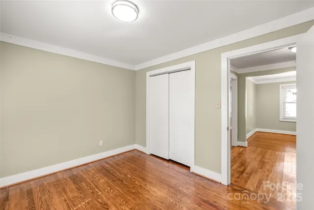 a view of hallway with wooden floor