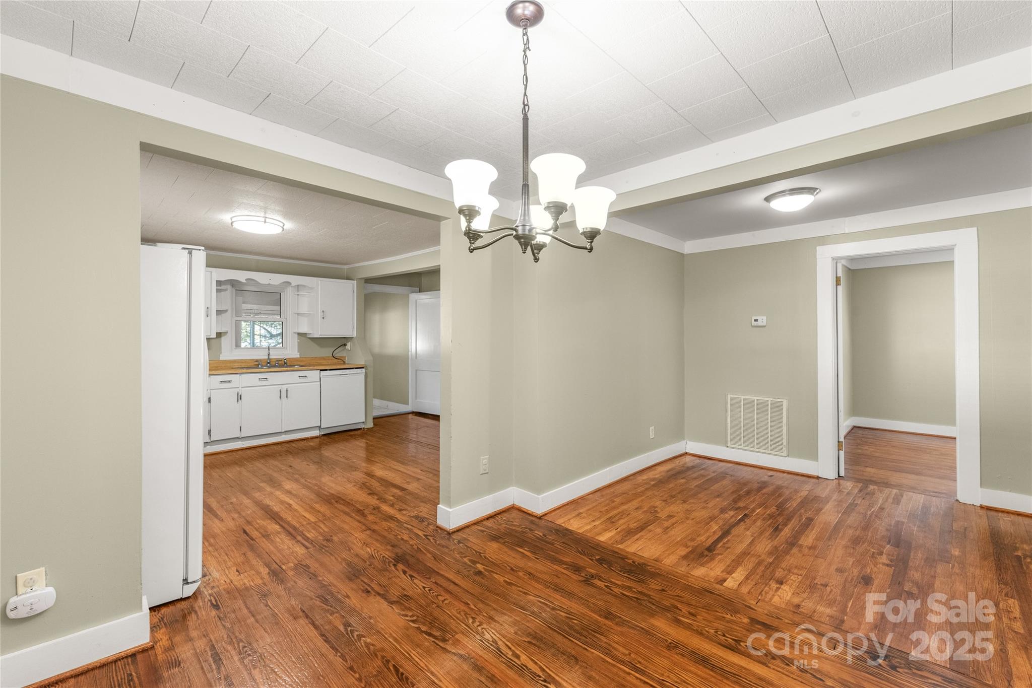 1914 John Moore Road Monroe, NC 28110 - Photo 14 of 27 a view of a room with wooden floor and a kitchen