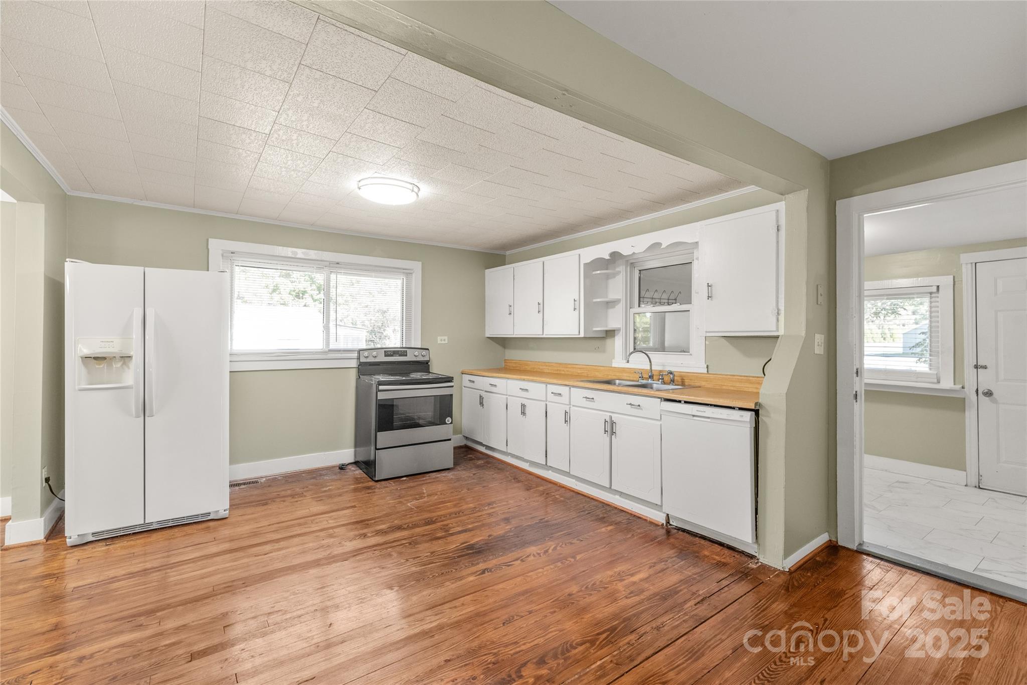 1914 John Moore Road Monroe, NC 28110 - Photo 16 of 27 a kitchen with granite countertop a refrigerator and white cabinets