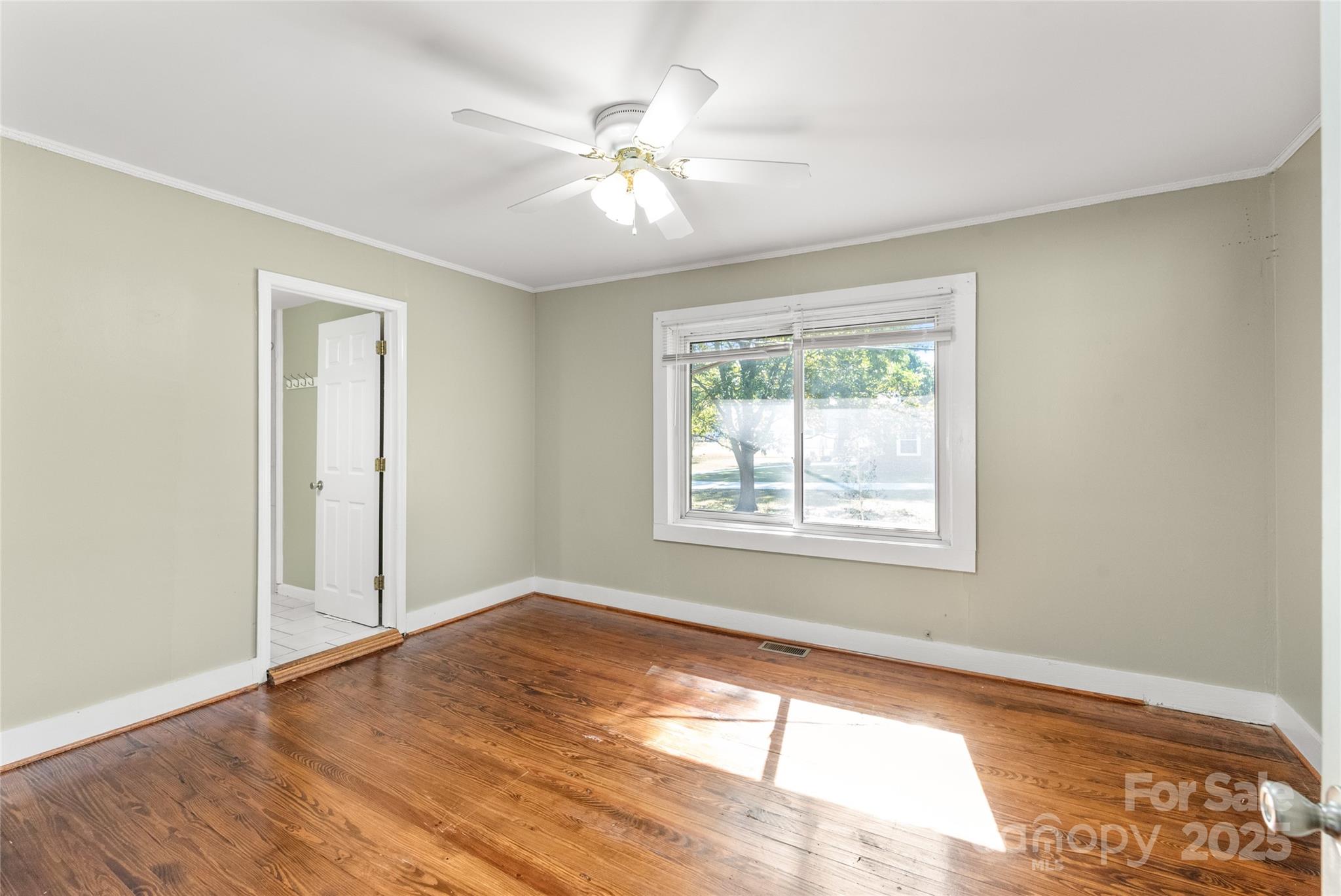 1914 John Moore Road Monroe, NC 28110 - Photo 18 of 27 a view of an empty room with wooden floor and a window