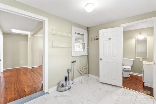 a view of a room with mirror and bathroom