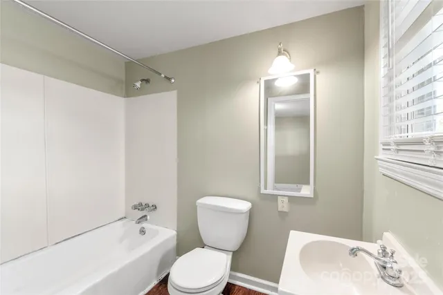 a bathroom with a toilet sink and shower