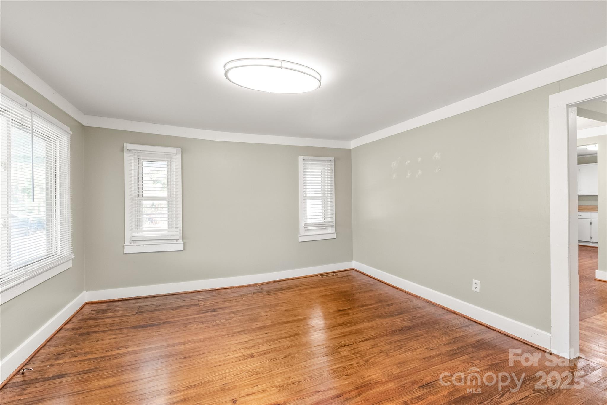 1914 John Moore Road Monroe, NC 28110 - Photo 4 of 27 a view of empty room with wooden floor and fan
