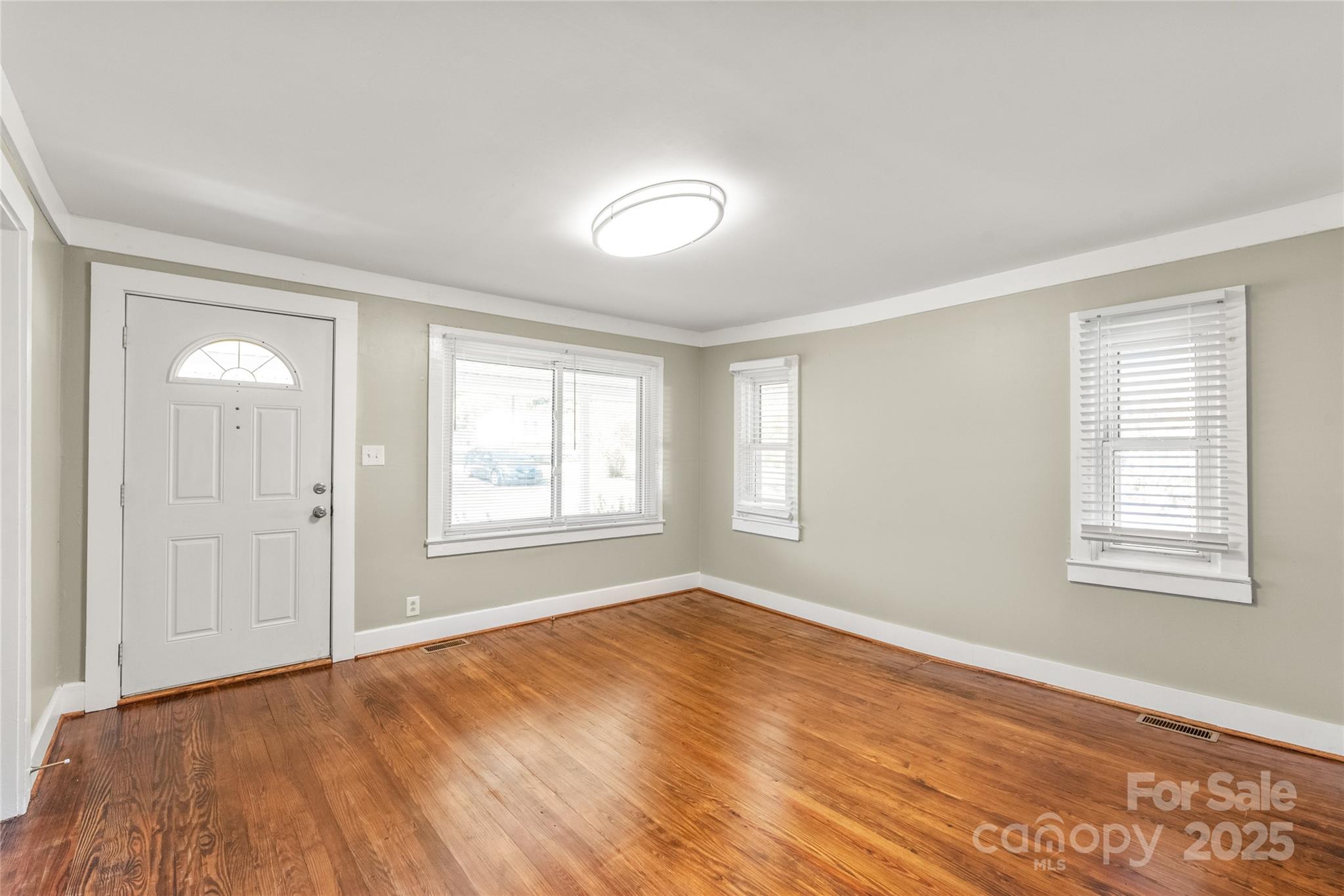 1914 John Moore Road Monroe, NC 28110 - Photo 5 of 27 a view of an empty room with wooden floor and a window