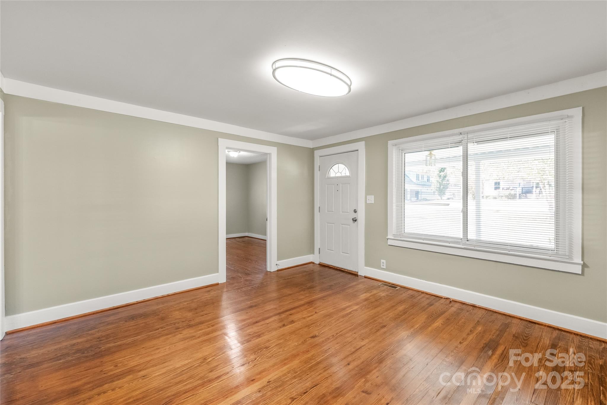 1914 John Moore Road Monroe, NC 28110 - Photo 6 of 27 a view of an empty room with wooden floor and a window