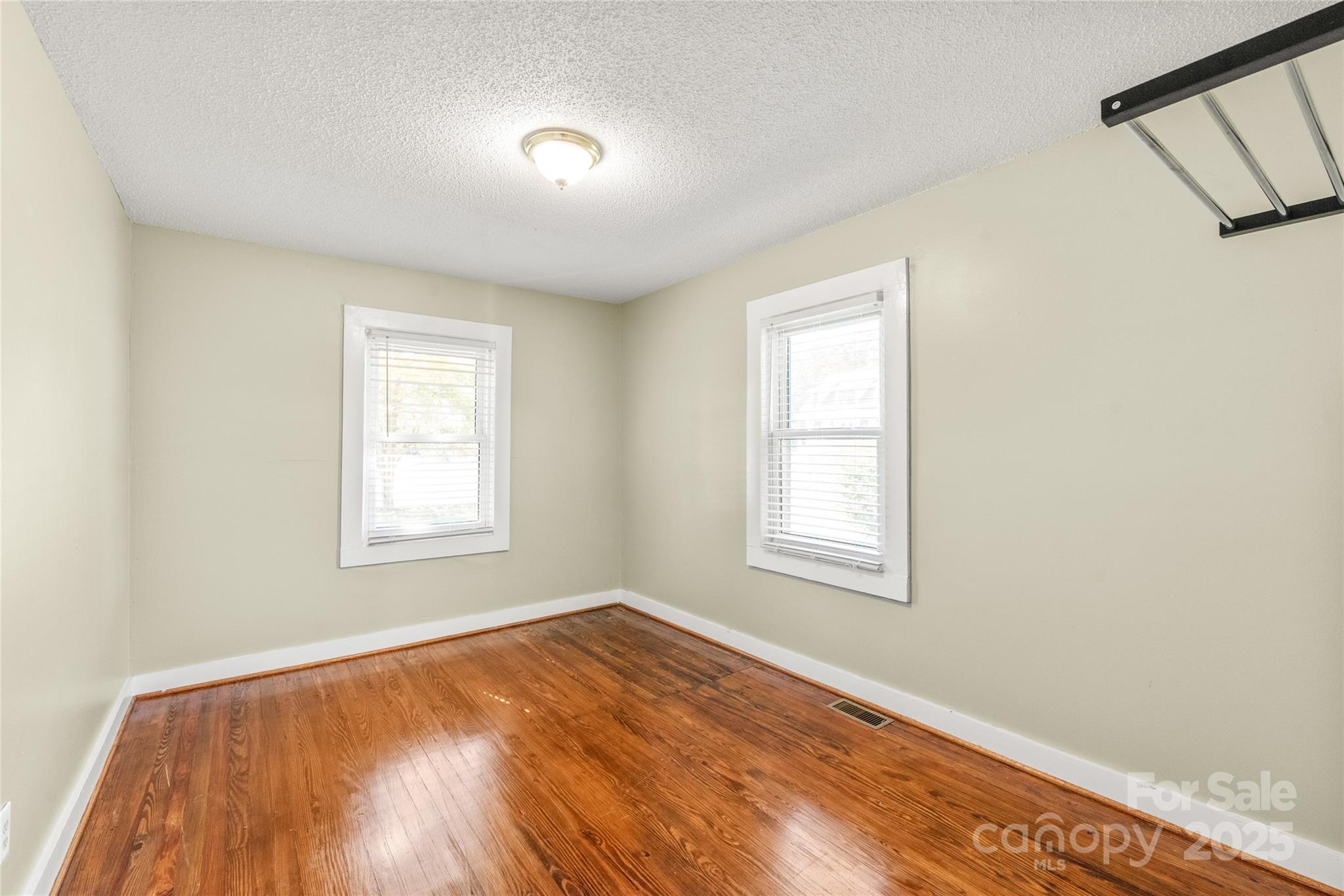 1914 John Moore Road Monroe, NC 28110 - Photo 8 of 27 an empty room with wooden floor and windows