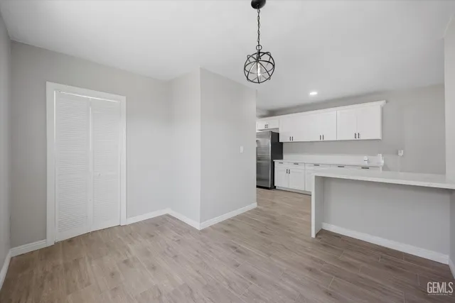 a kitchen with white cabinets and white appliances