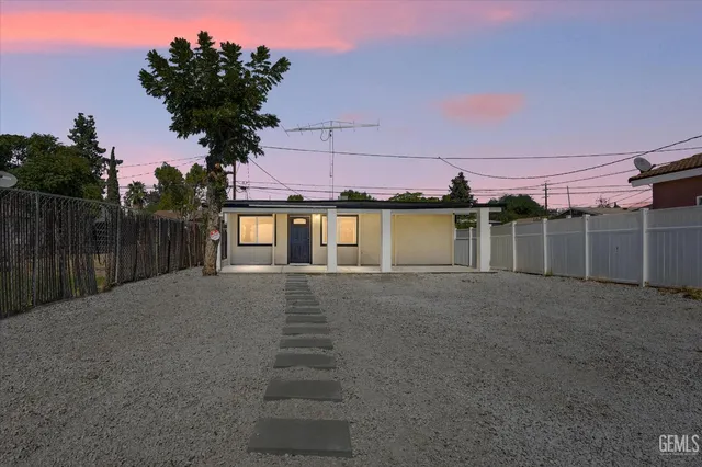 a view of a house with a yard and a garage