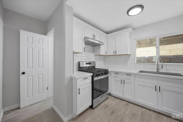 a kitchen with a sink and cabinets
