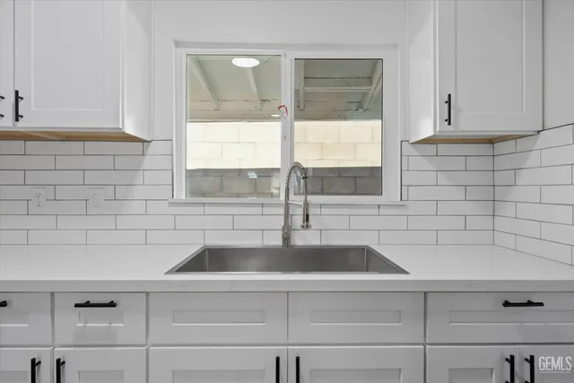a kitchen with a sink and cabinets