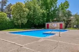 a swimming pool with outdoor seating and yard