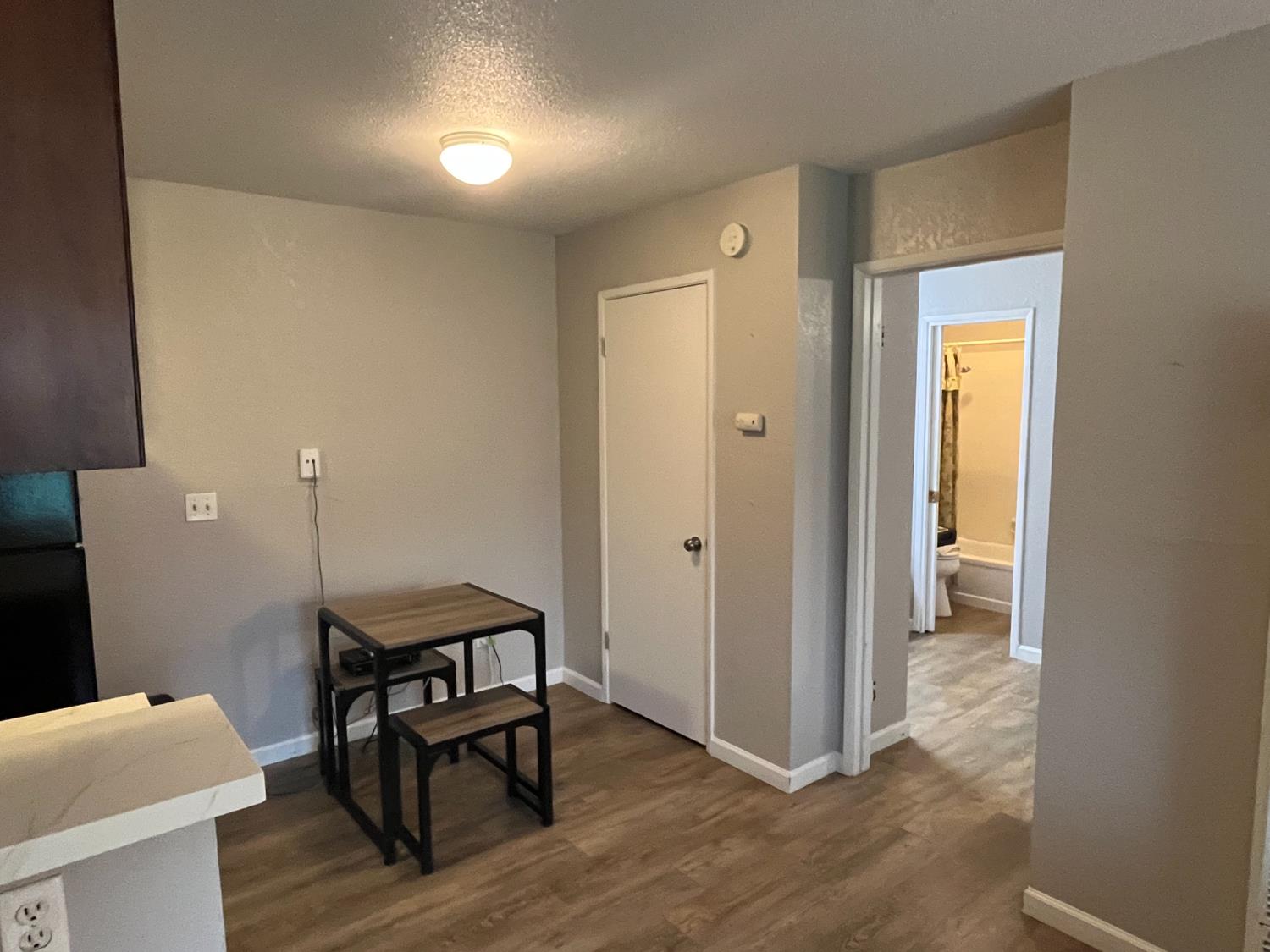 6724 Plymouth Road, Unit 33 Stockton, CA 95207 - Photo 7 of 12 a view of a hallway and dining room with furniture