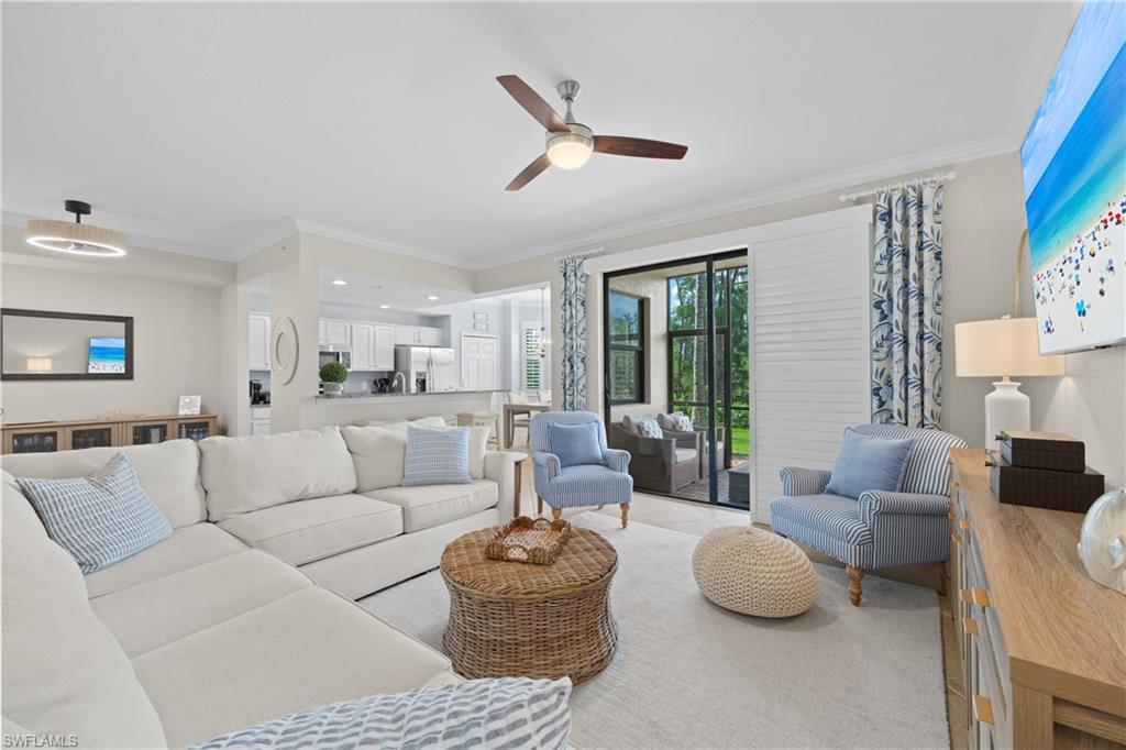 9715 Acqua Court, Unit 116 Naples, FL 34113 - Photo 3 of 43 a living room with furniture and a large window