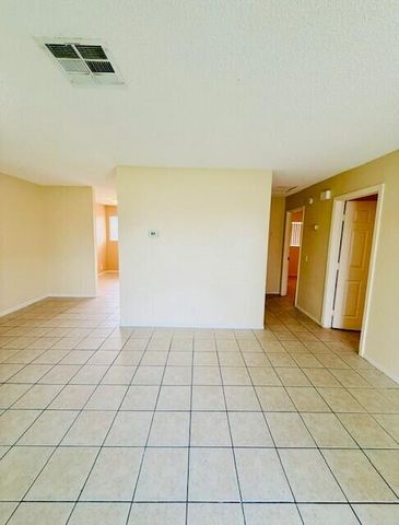 a view of a livingroom with an empty space and a window