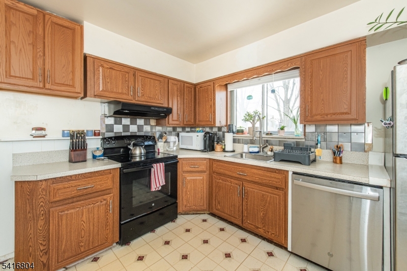 26 Green Road Mine Hill, NJ 07803 - Photo 15 of 21 a kitchen with stainless steel appliances granite countertop a stove sink microwave and cabinets