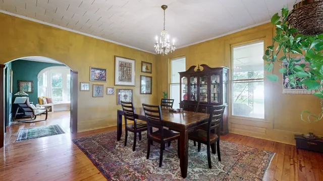 a view of a dining room with furniture window and wooden floor