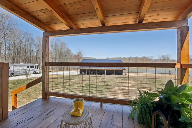 a room with patio chairs and a potted plant